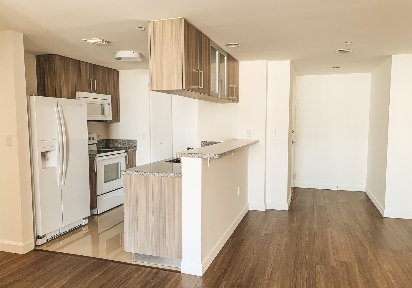 Modern kitchen with granite countertops and wood cabinetry